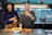 a couple of women standing next to each other in a kitchen