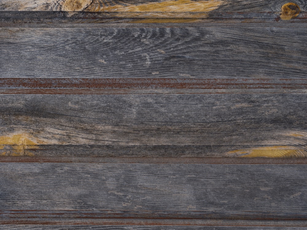 a close up of a wooden surface with yellow paint