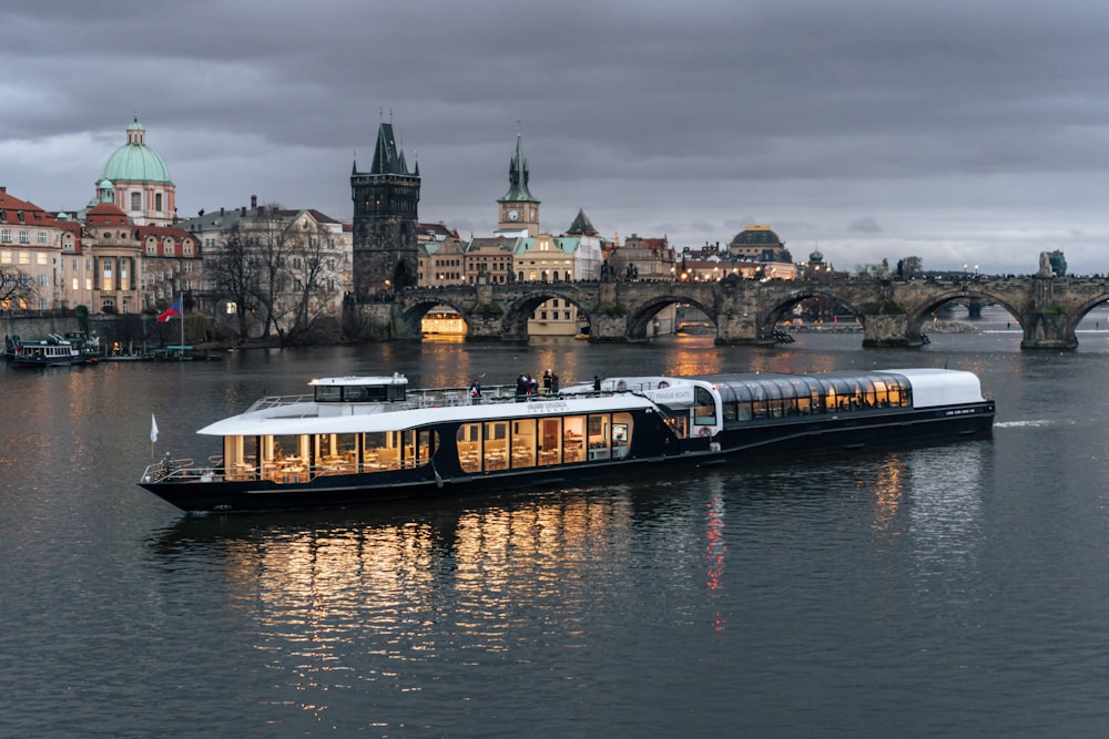 a large boat on a river near a bridge