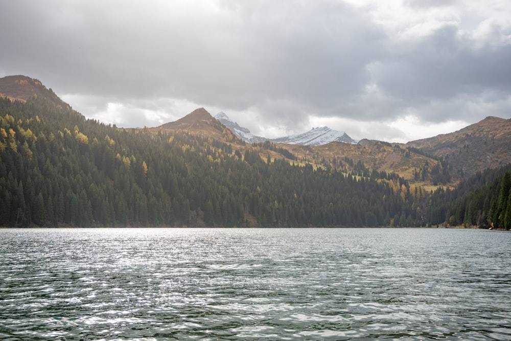 a body of water with mountains in the background