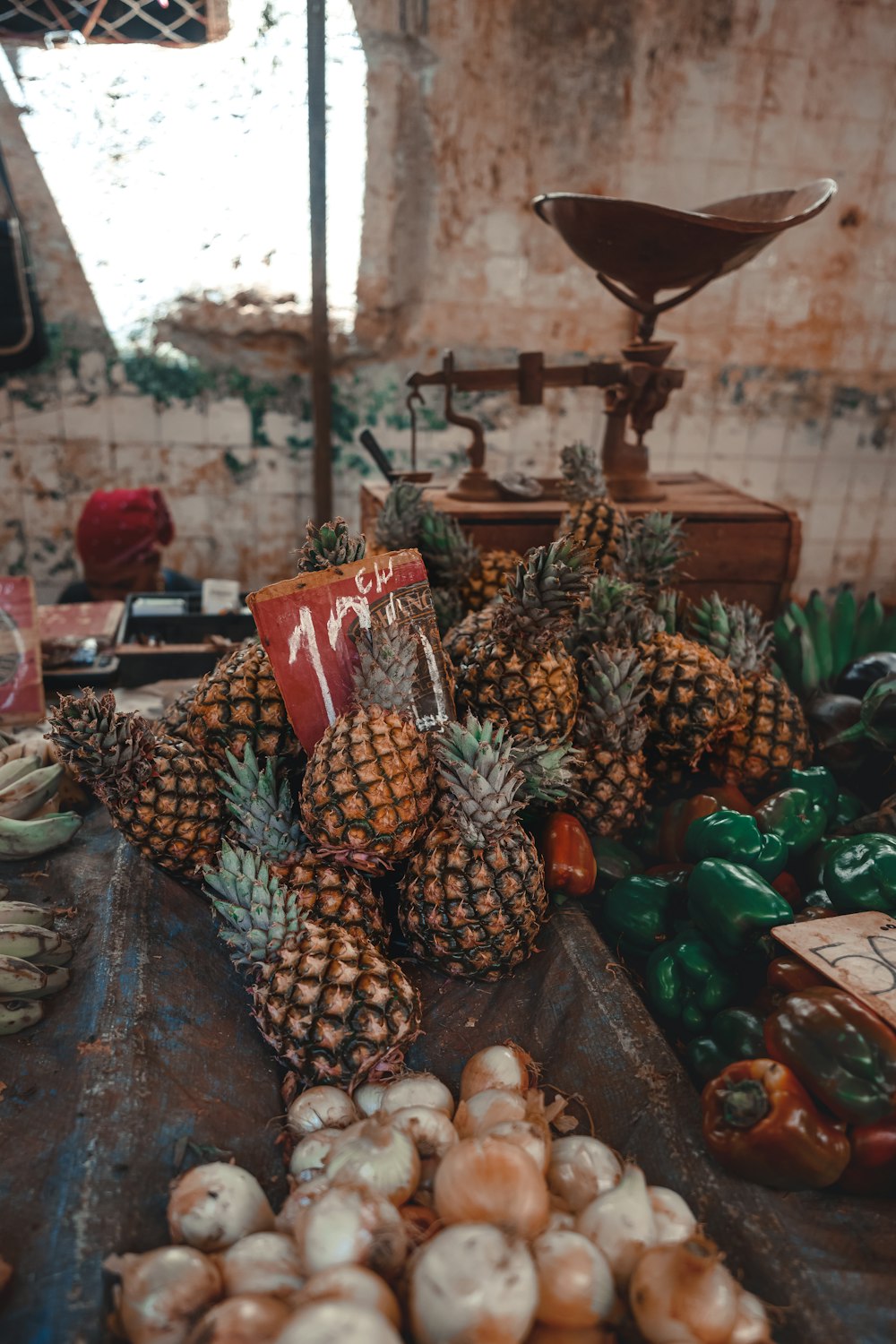 a table topped with lots of pineapples and other fruits