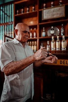 a man in a white shirt holding something in his hands