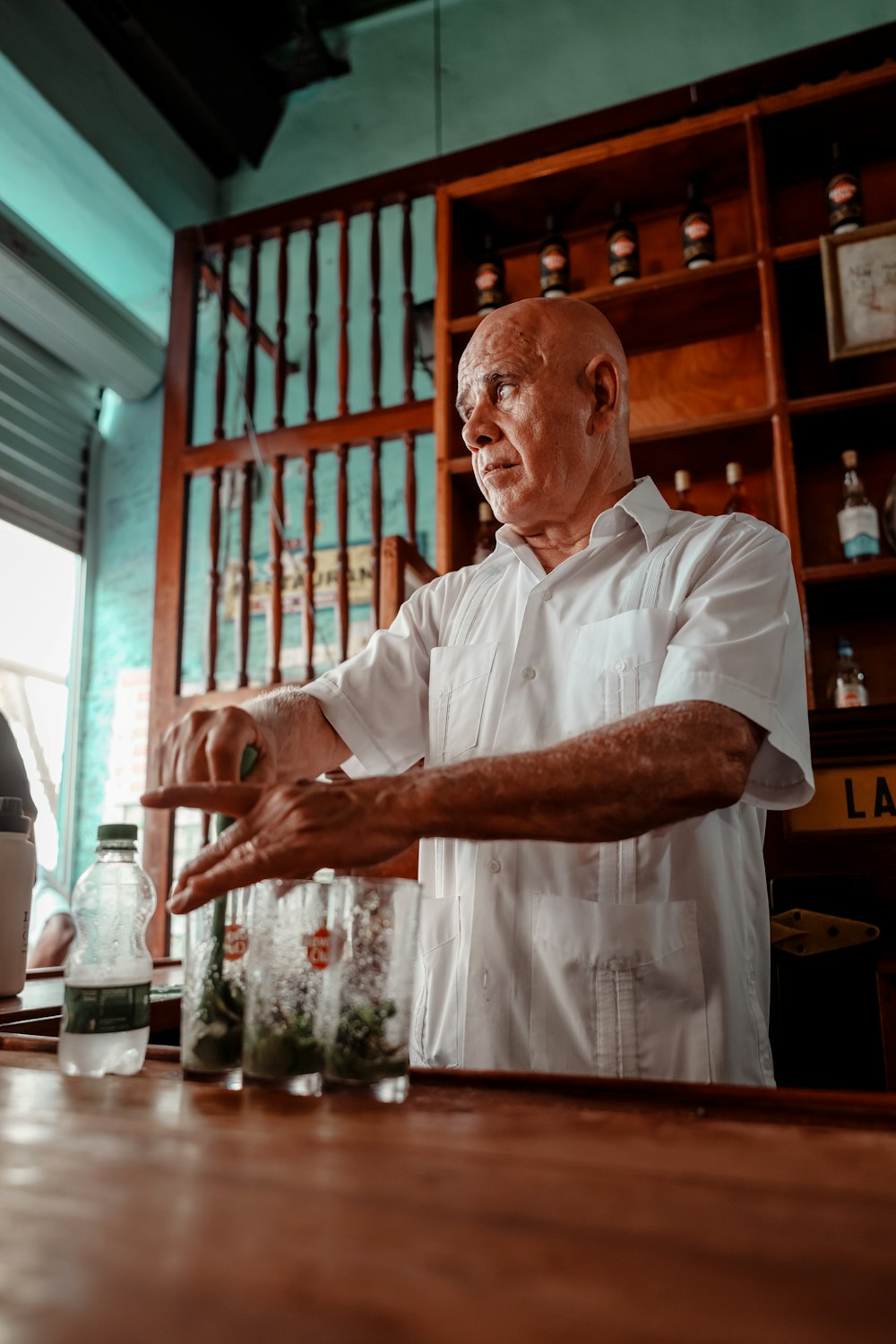 a man standing in front of a wooden table