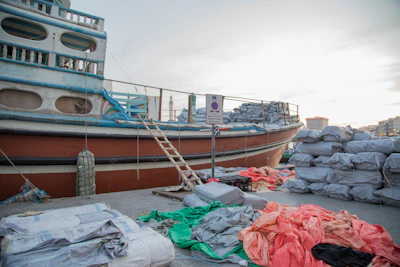 A friendly agent explaining import regulations to a customer beside a used boat