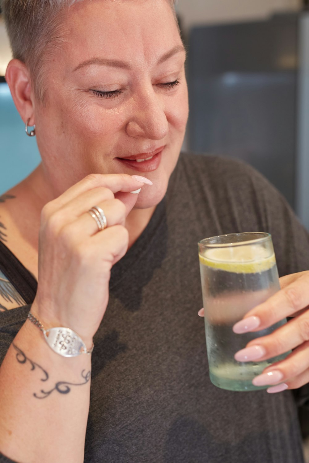 a woman holding a glass of liquid in her hand