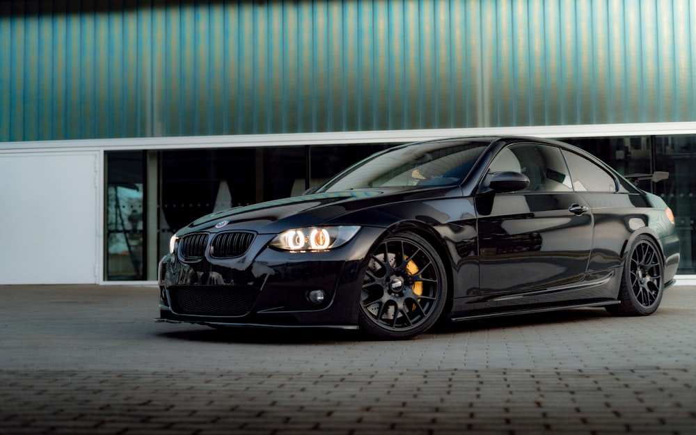 a black car parked in front of a building