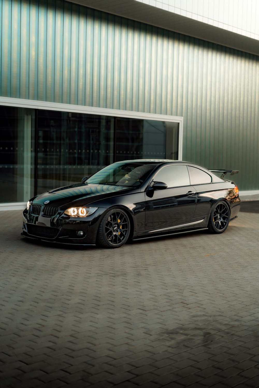 a black car parked in front of a building