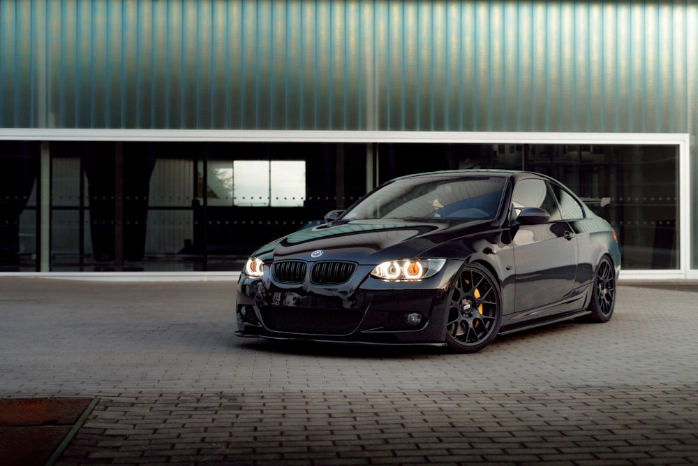 a black car parked in front of a building