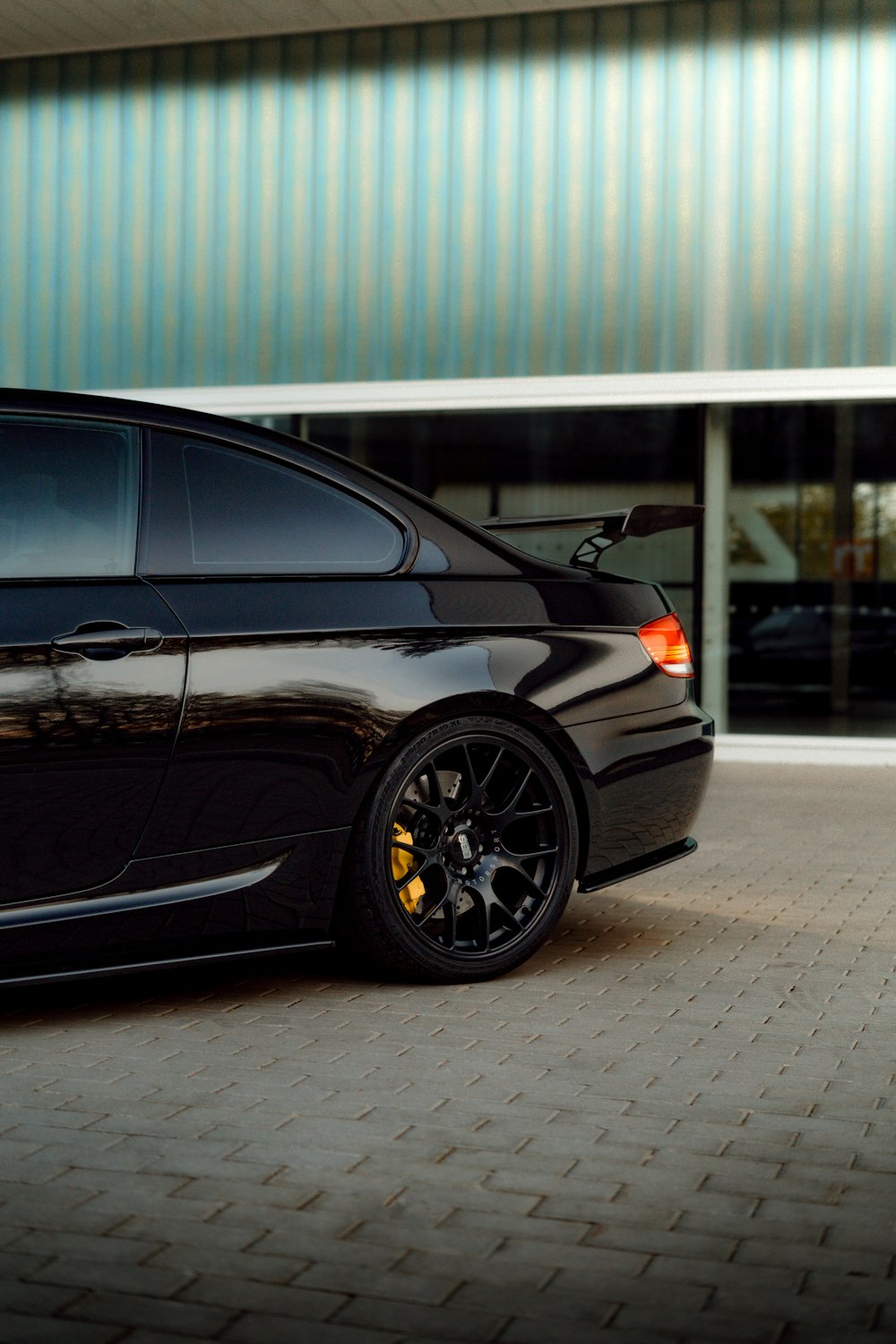 a black car parked in front of a building