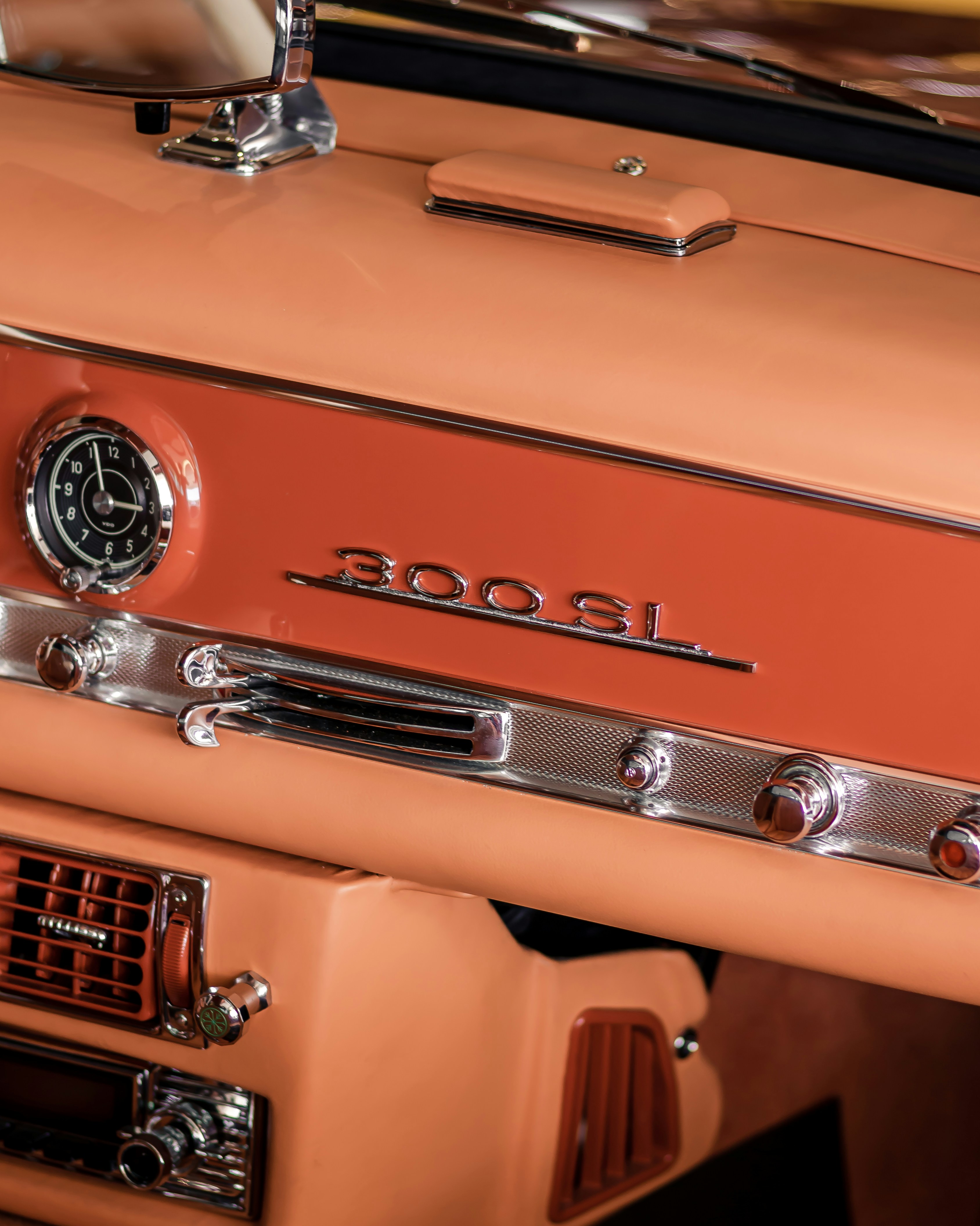 a close up of a car dashboard with a clock