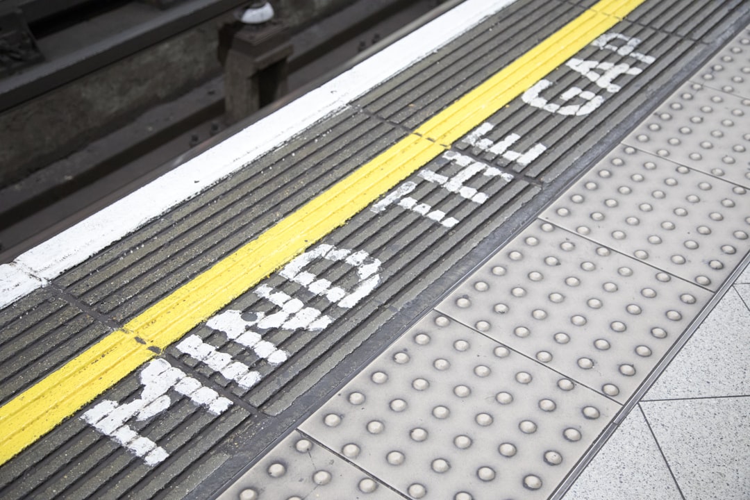 a train platform with the word train stop painted on it