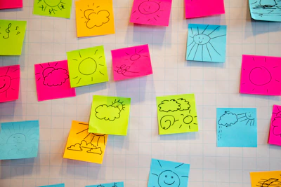 Sticky notes and decorative stickers with playful shapes and pastel colors on a light background