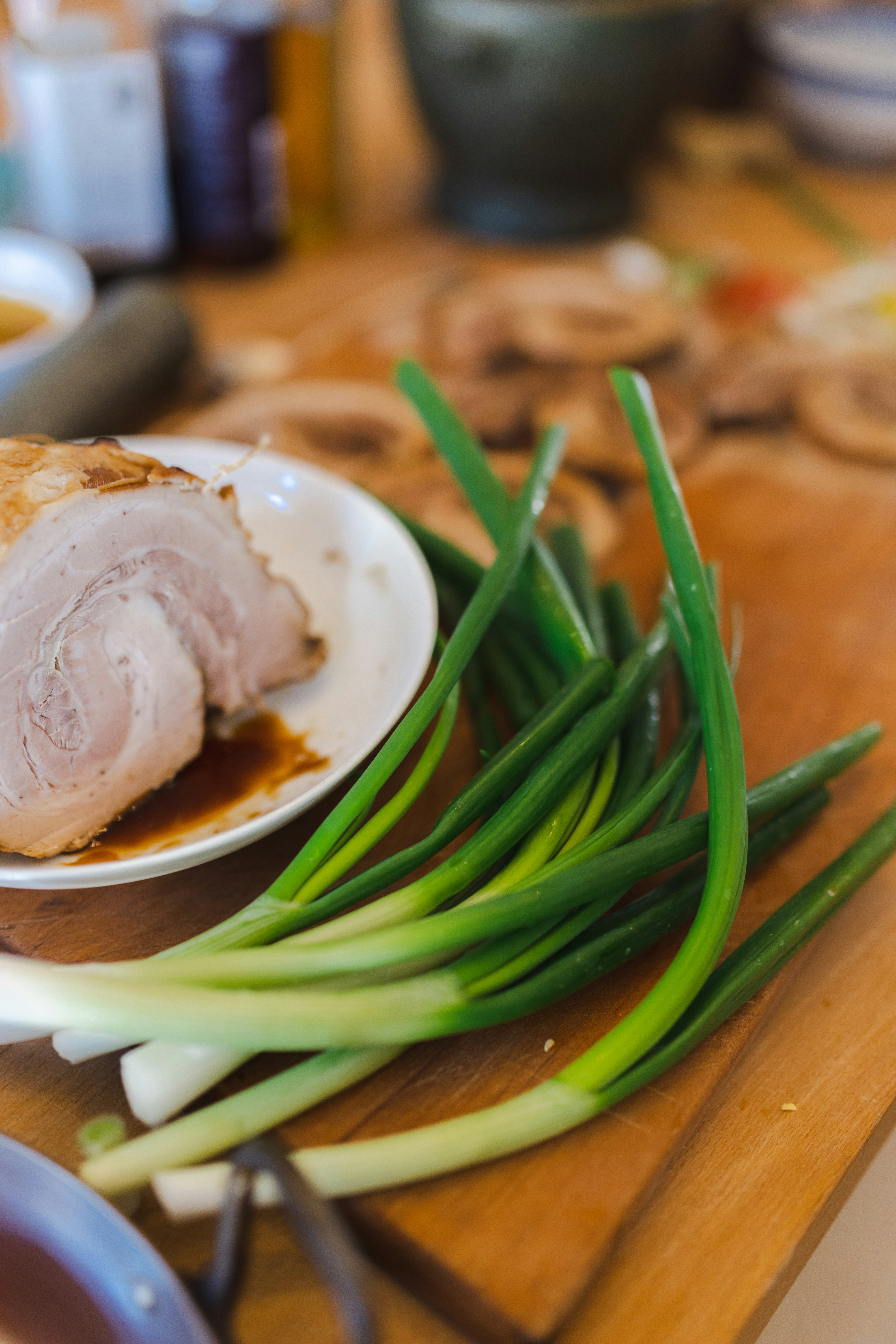 a white plate topped with meat and green onions