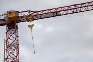 a crane is lifting a yellow sign into the air