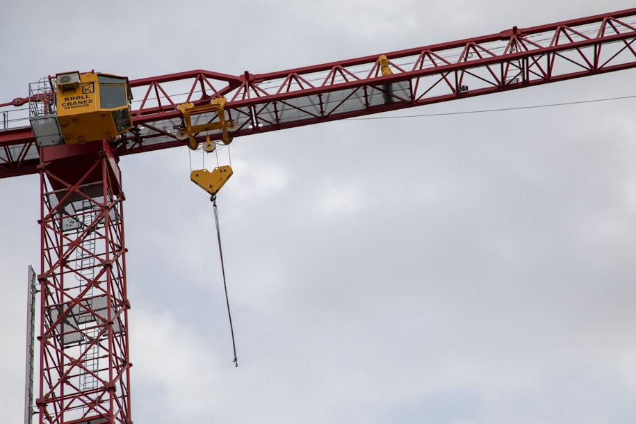 a crane is lifting a yellow sign into the air