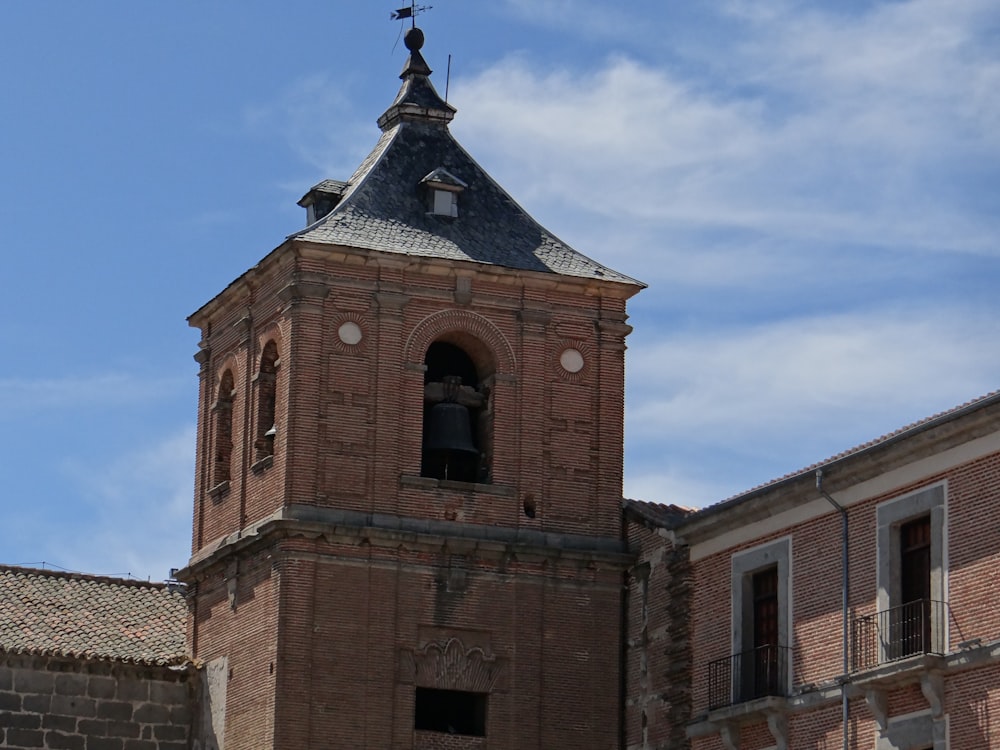 a tall brick building with a bell tower