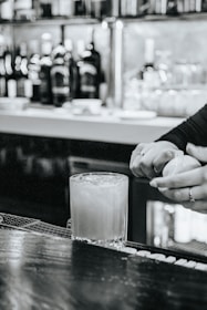 A close-up of a robotic system meticulously crafting a cocktail.
