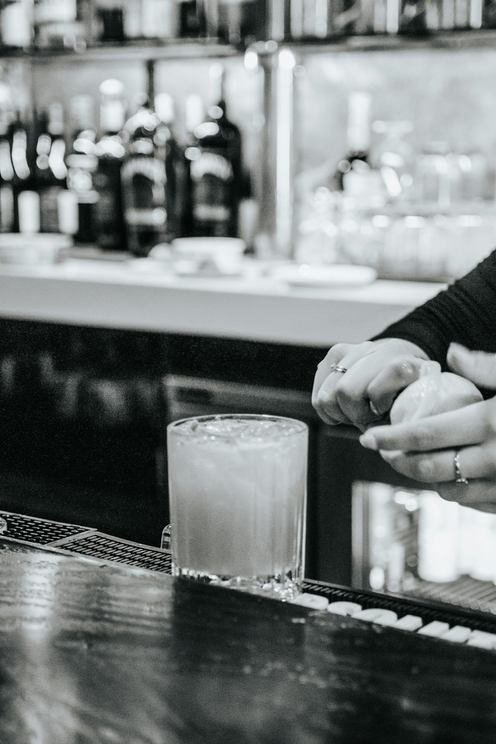 a woman holding a glass of milk in front of a bar