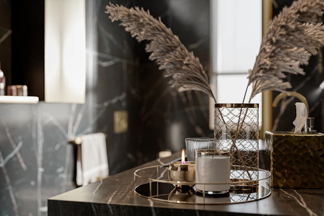 Black marble vanity with gold veins, candles and dried pampas grass
