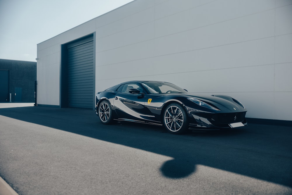 a black sports car parked in front of a building