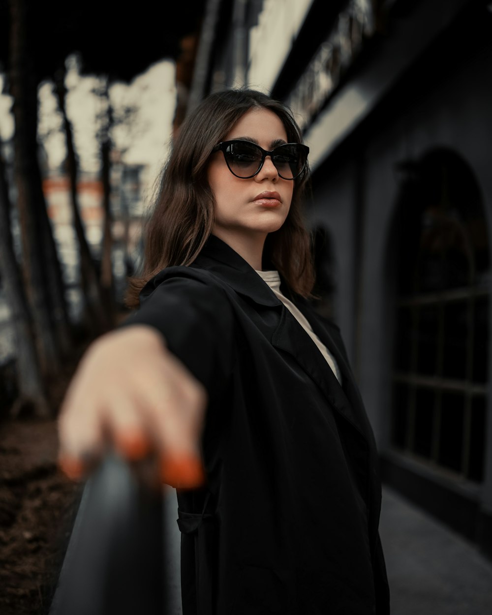 a woman wearing sunglasses and a black coat