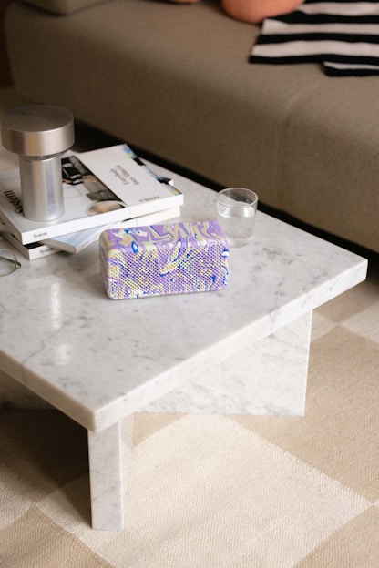 A sleek marble coffee table bathed in natural light, showcasing its smooth surface and subtle veining.