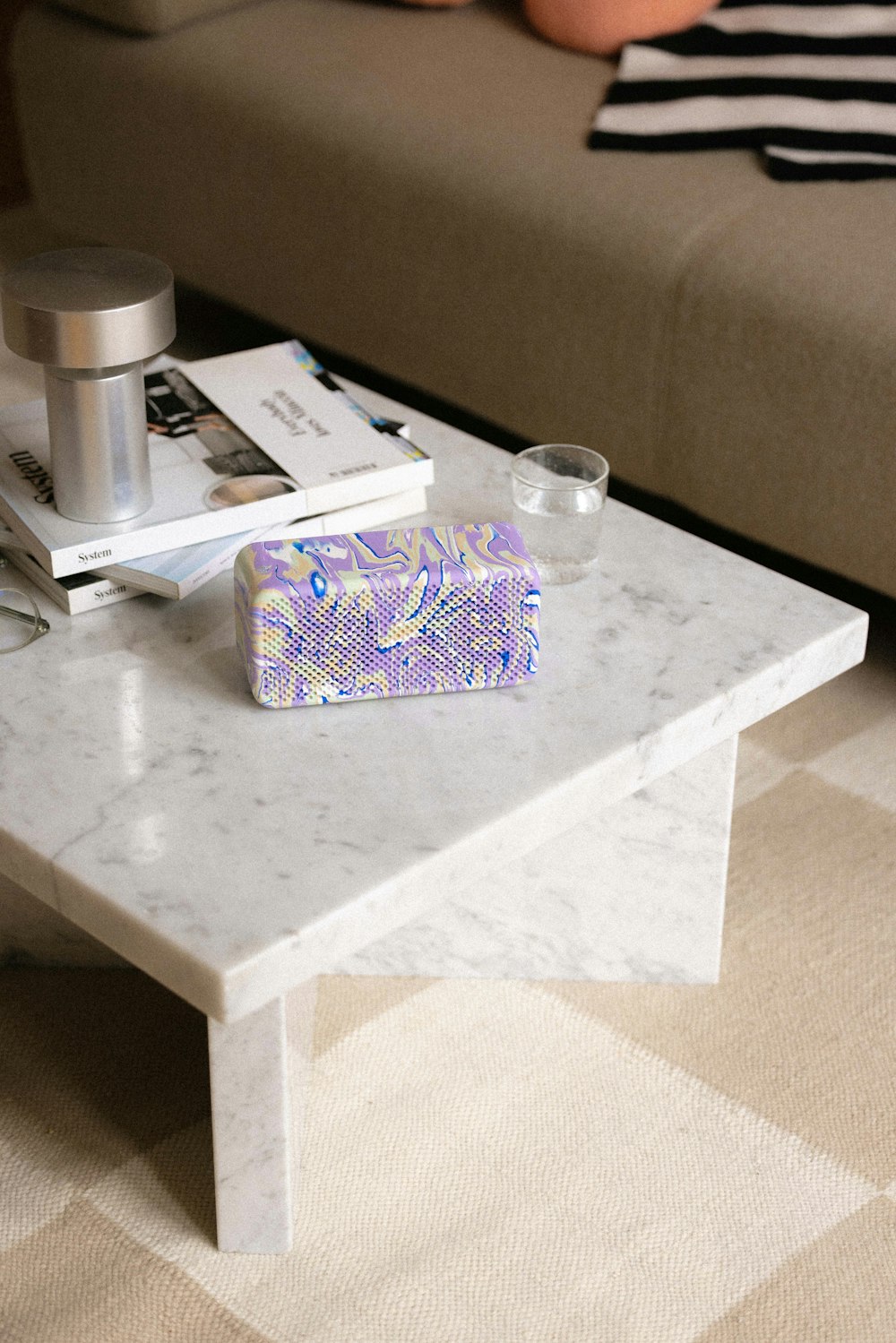 a marble coffee table with a cell phone on top of it