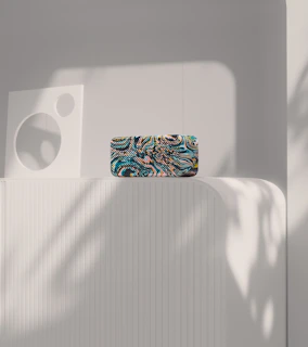 Close-up of a bright, geometric 3D plastic decoration piece mounted on a white wall.