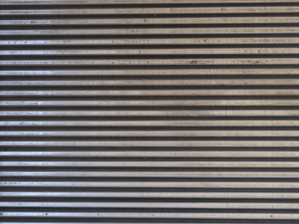 a close up of a metal surface with vertical lines