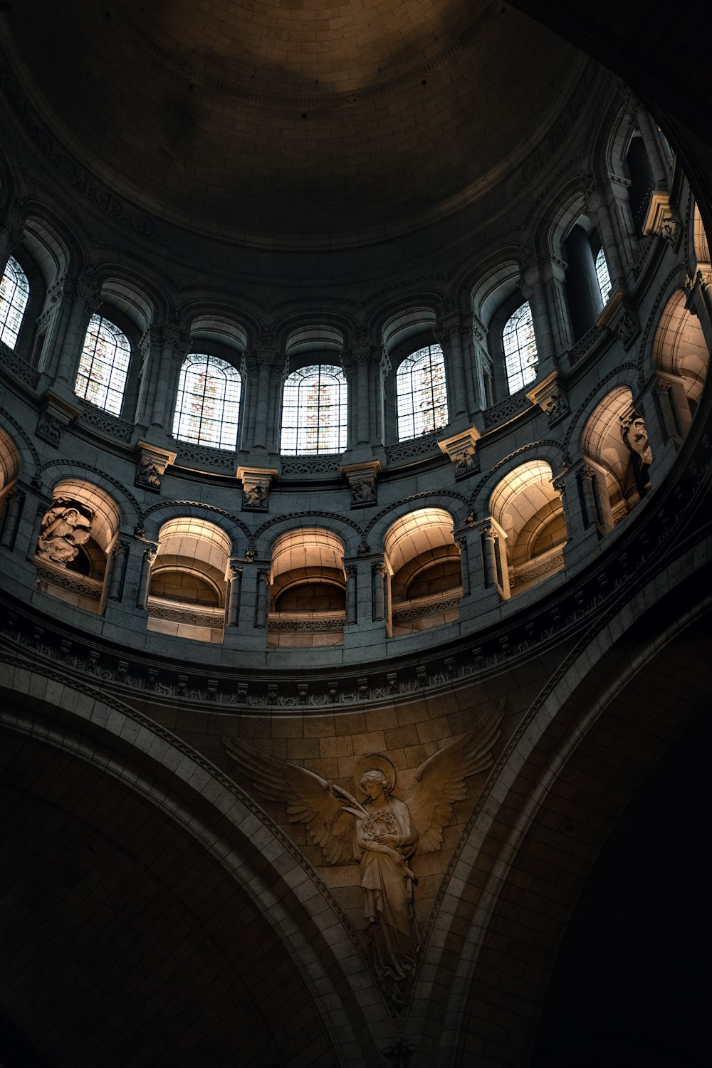 a circular room with a statue of an angel in the center