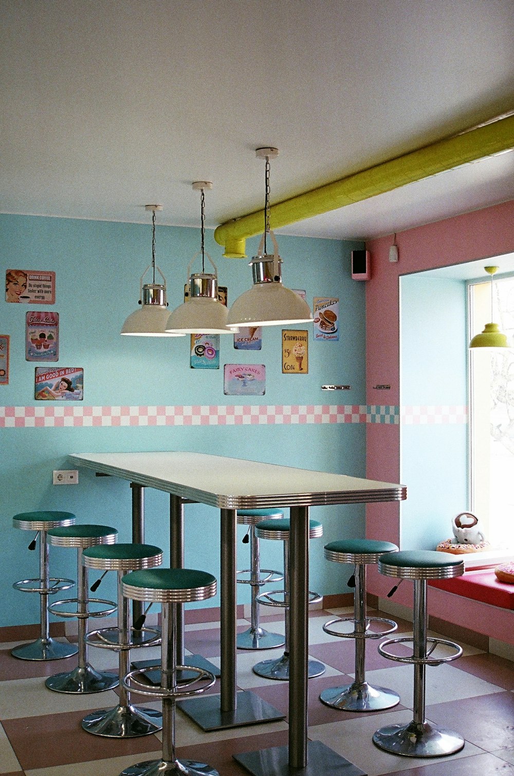 a room with several stools and a table in it