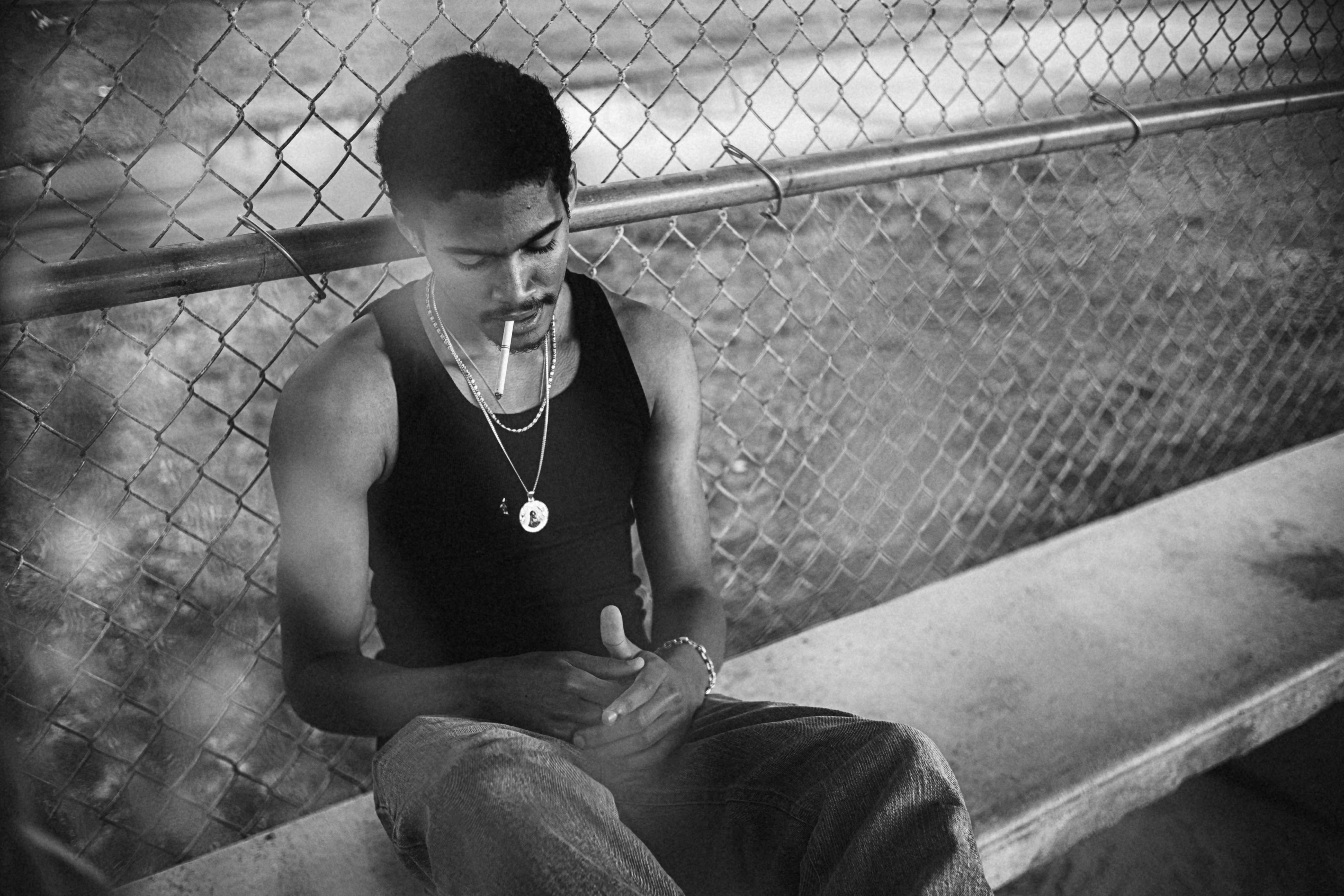 a man sitting on a bench looking at his cell phone