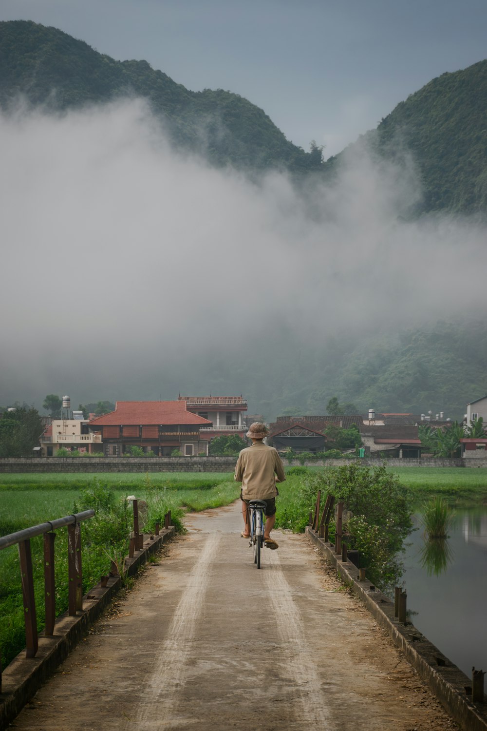 a person riding a bike on a bridge