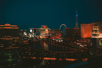 A vibrant cityscape showcasing famous landmarks lit up at night, symbolizing global travel.