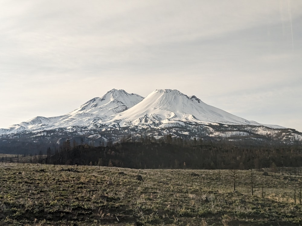 a large snow covered mountain in the distance