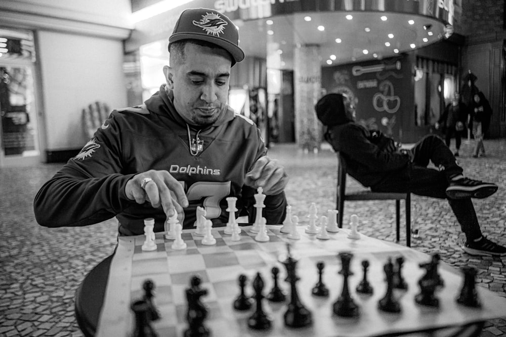 a man playing a game of chess in a mall