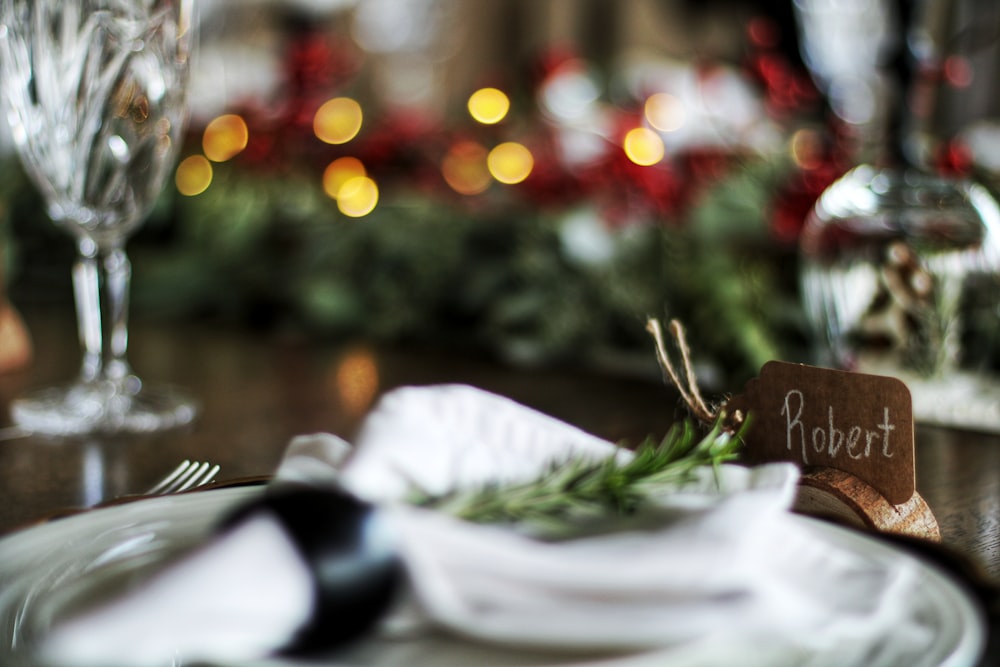 a place setting with a place card on a plate