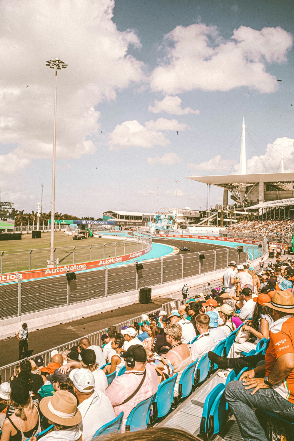 a crowd of people sitting in chairs at a race track