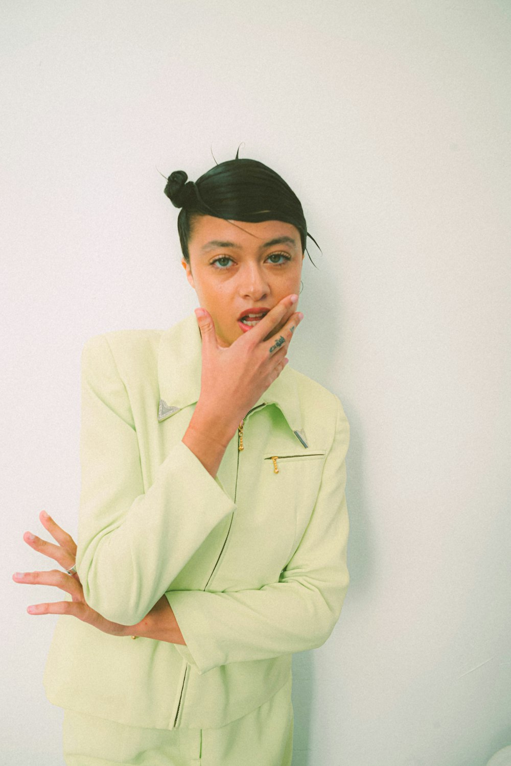 a woman in a green suit posing for a picture