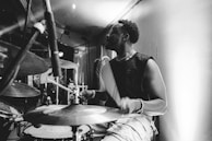 Close-up of a drummer mid-beat, sweat and passion visible on his face.