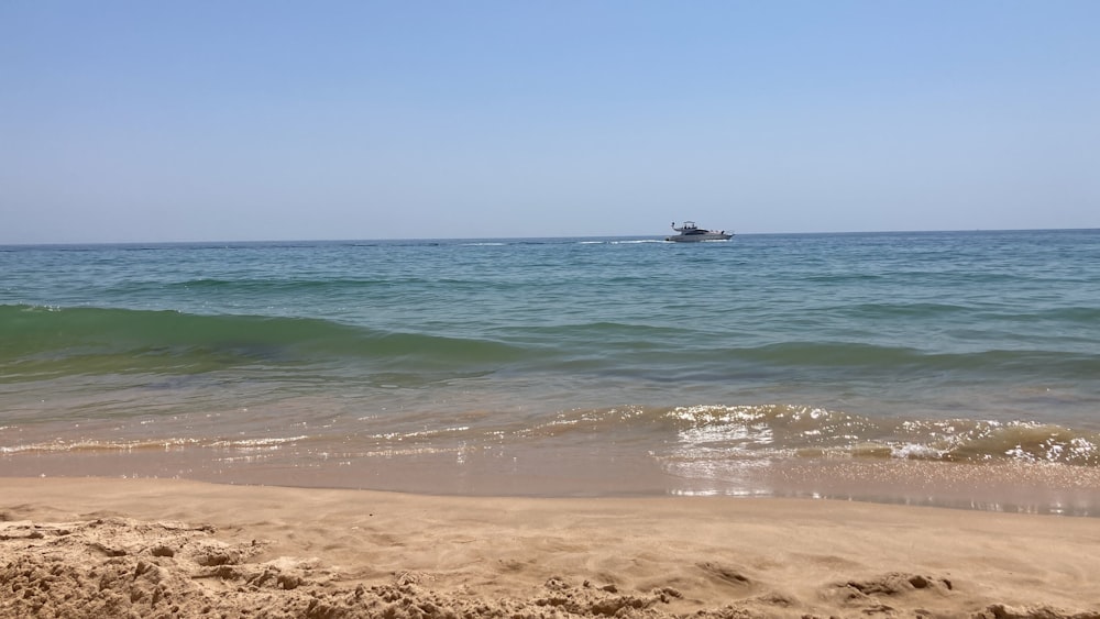 a boat is out in the ocean on a sunny day