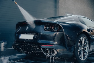 a car being washed with a high pressure washer