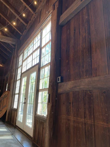 Spacious Wendy house interior showing neat storage shelves and natural light streaming through windows.