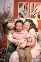 A family at home celebrating financial relief with warm embraces.