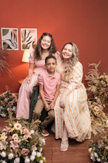 A warm photo of Daniela smiling with her family in a cozy, softly lit room