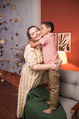 a woman holding a small child in her arms