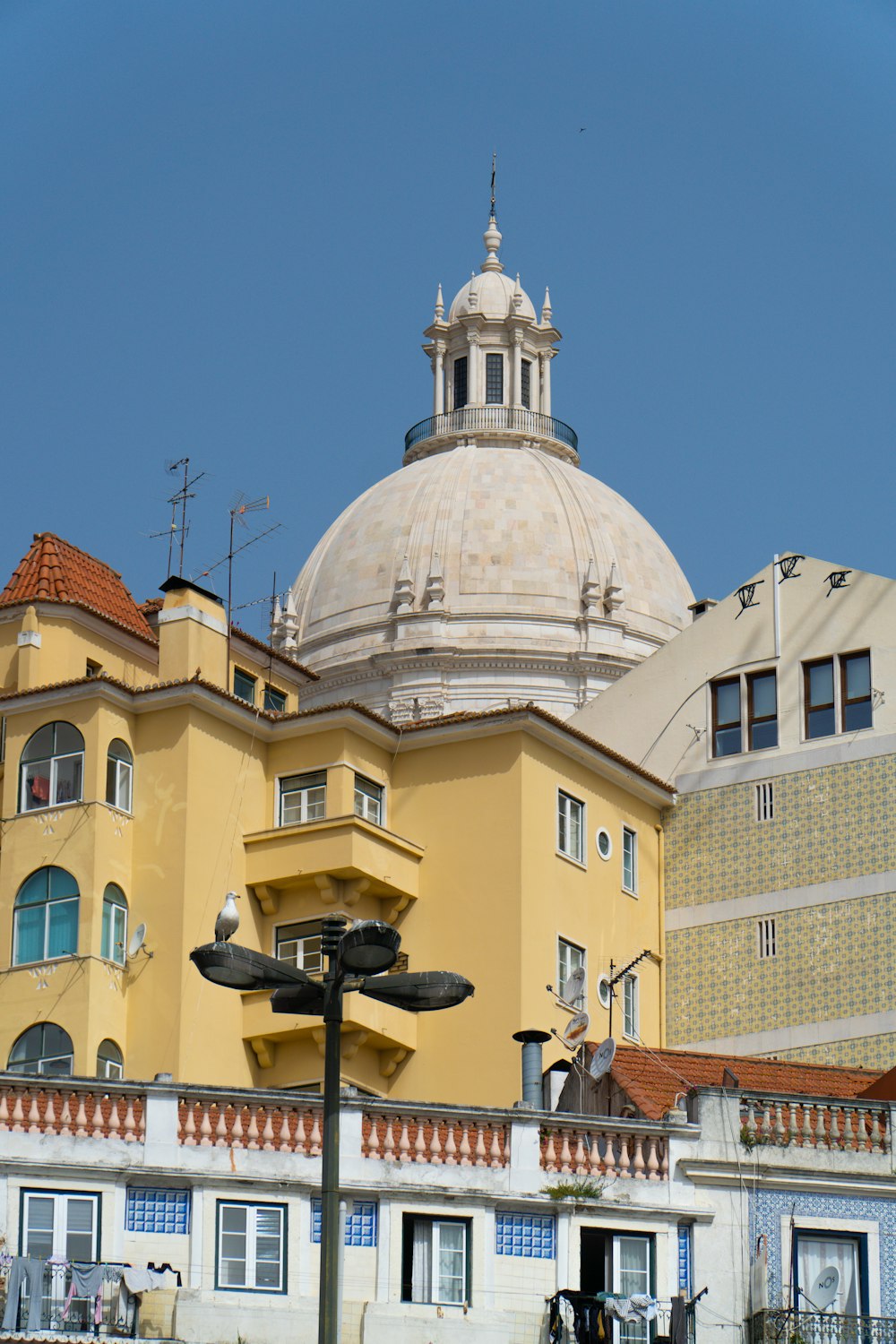 a large yellow building with a dome on top