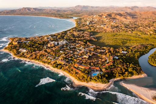an aerial view of a tropical island with a beach