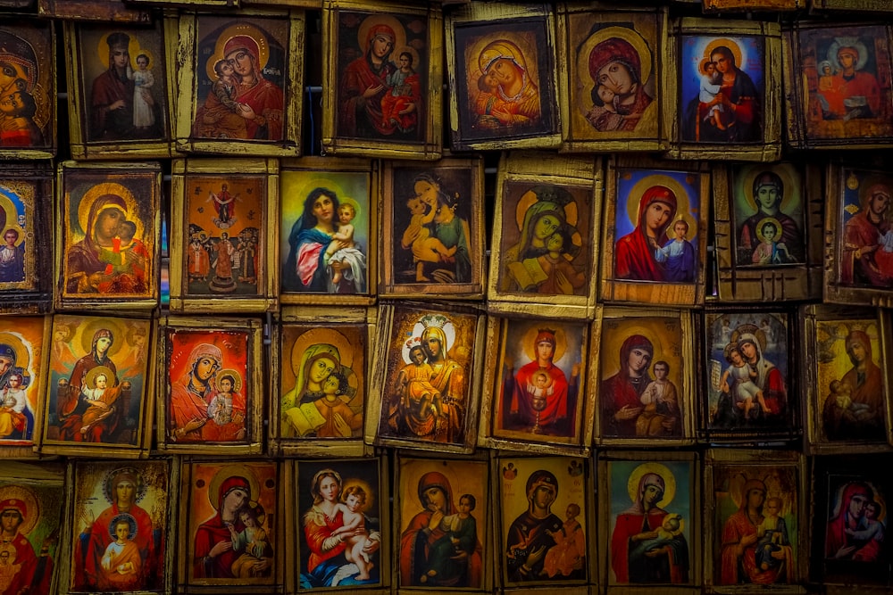 a wall full of religious icons and paintings
