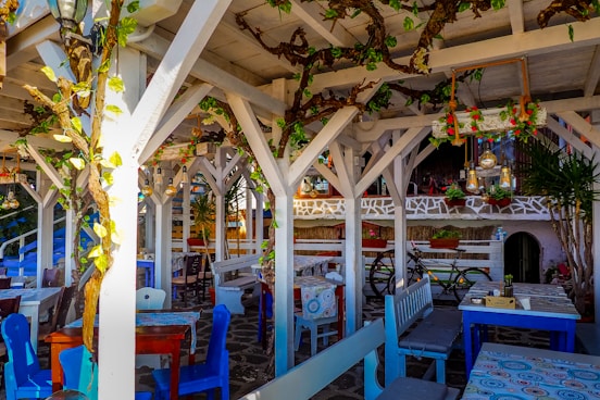 an outdoor dining area with tables and chairs